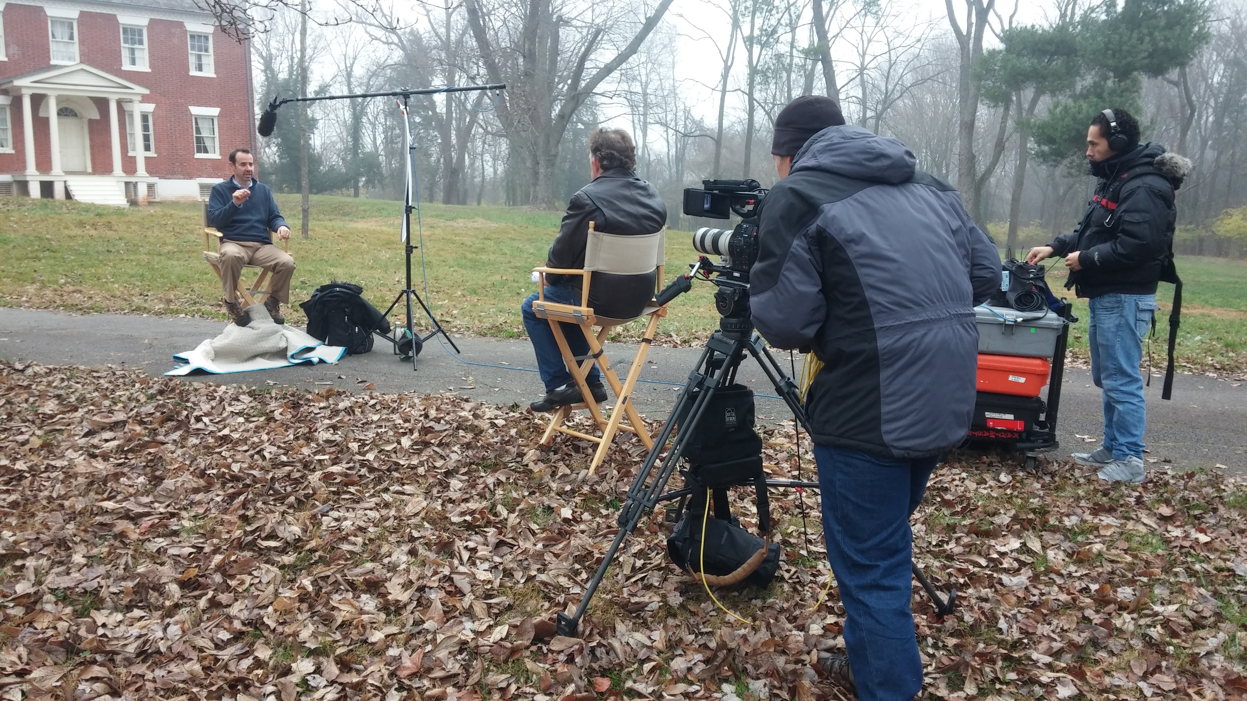 Film crew filming at a misty estate