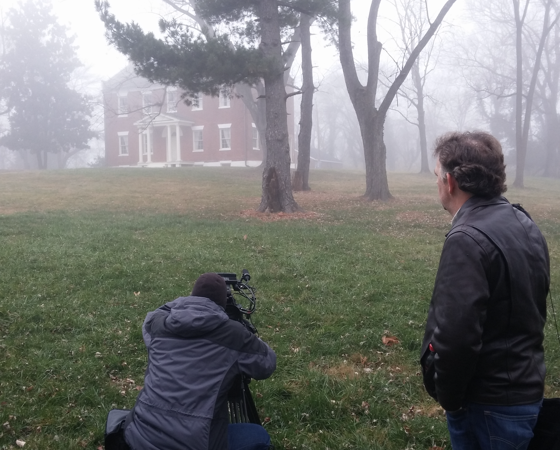 Film crew shooting in foggy field